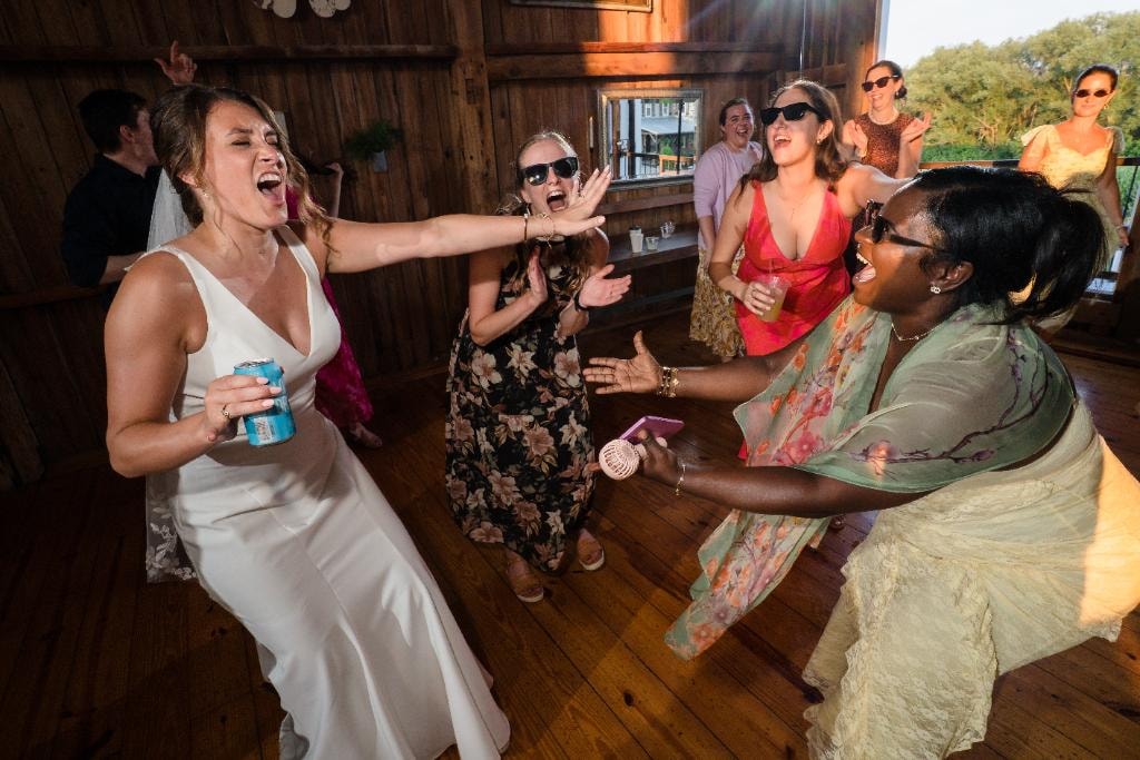 Bride and guests celebrating at wedding reception