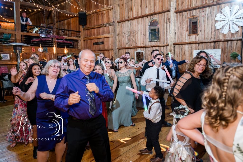 Full dance floor at rustic barn wedding reception