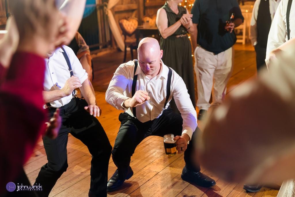 Guests dancing energetically at wedding reception